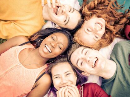 Group of friends having fun laying down