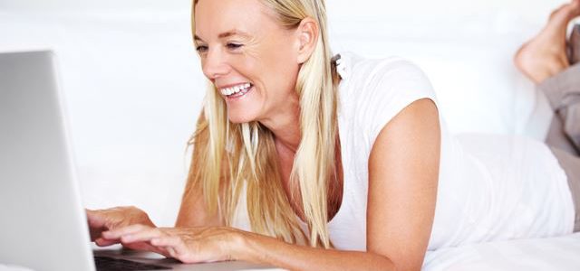 Woman smiling on laptop